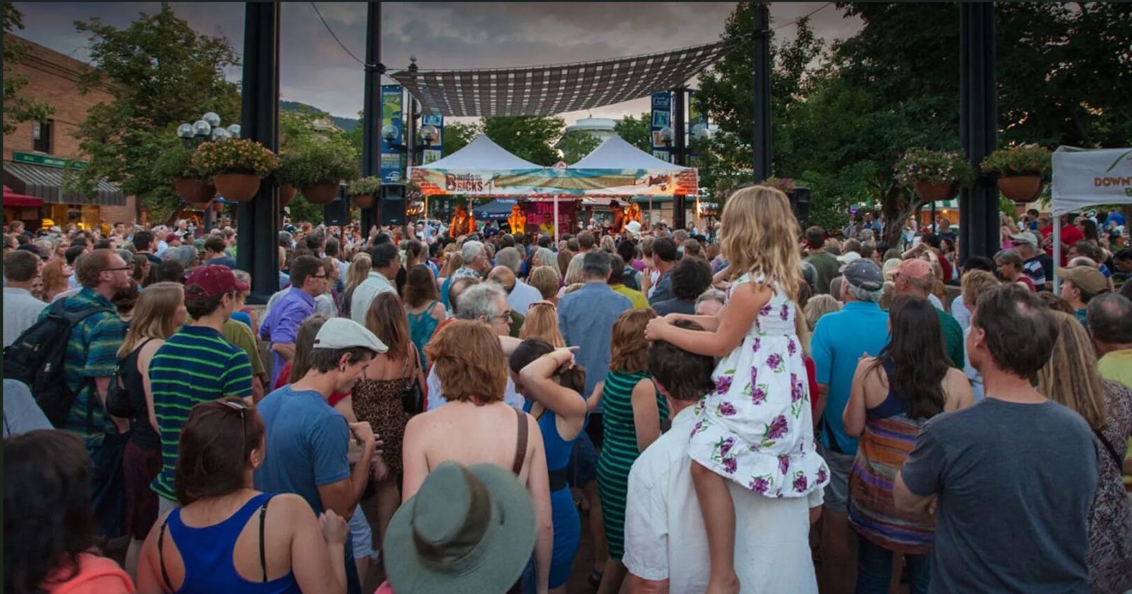 Visitors attending a summer concert in Boulder, Colorado, near Longmont and Boulder County lodging options.